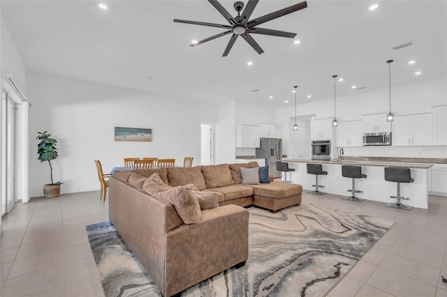 tiled living room with sink and ceiling fan