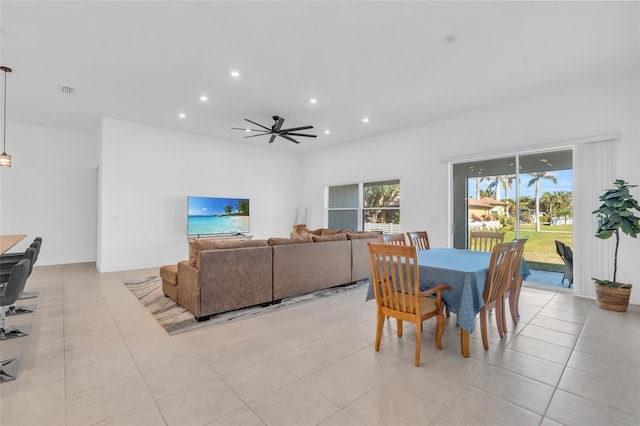 dining space with ceiling fan and light tile patterned flooring