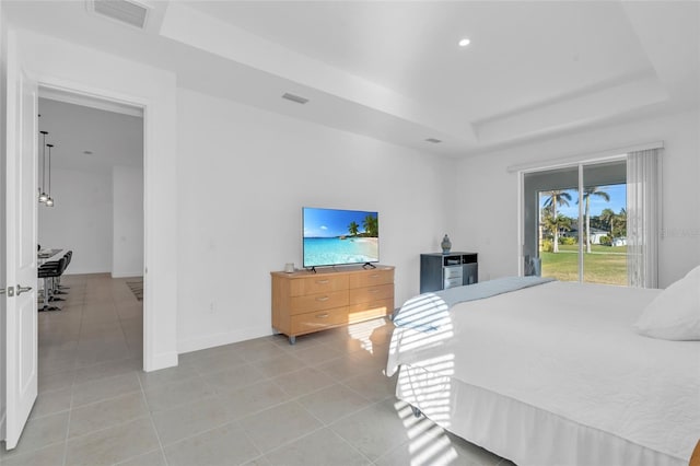 bedroom featuring access to outside, a raised ceiling, and light tile patterned flooring