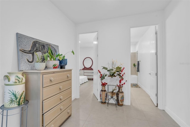 hall with light tile patterned floors