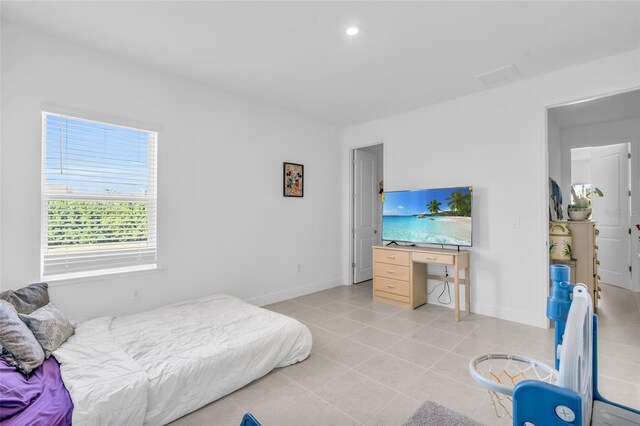 bedroom featuring light tile patterned flooring