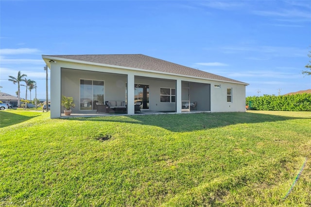 back of property featuring a lawn