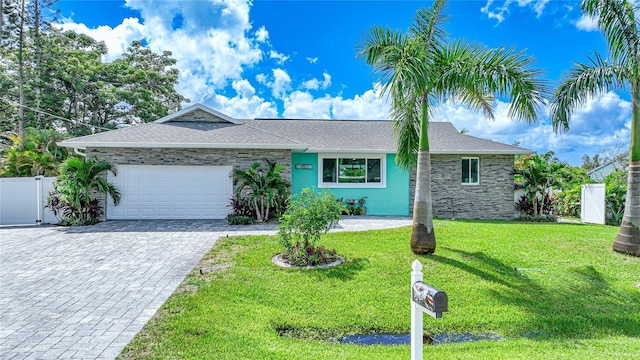 ranch-style house with a garage and a front lawn