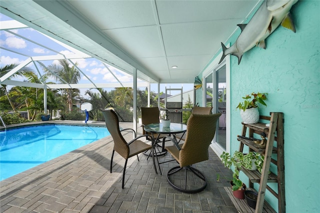 view of pool with a grill, a lanai, and a patio area