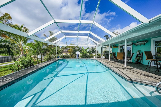 view of pool with a patio and a lanai