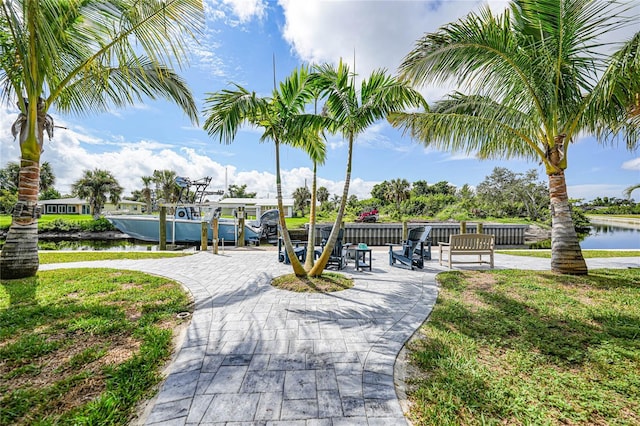 view of community with a boat dock and a water view