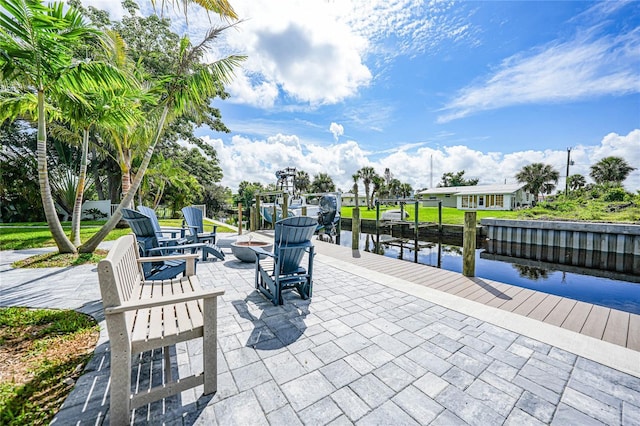 view of patio with a boat dock and a water view