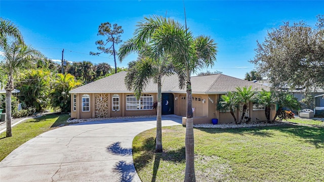 single story home featuring a garage and a front yard