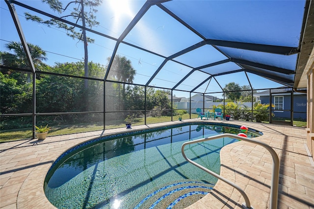 view of swimming pool with a lanai and a patio area