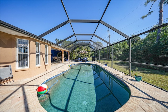 view of swimming pool featuring a patio area and glass enclosure