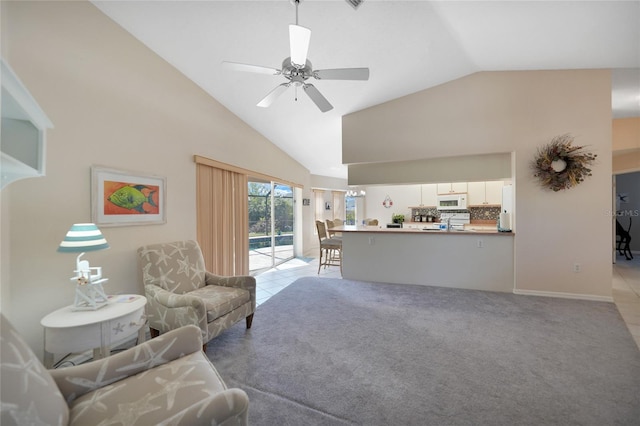 living room with high vaulted ceiling, light carpet, and ceiling fan