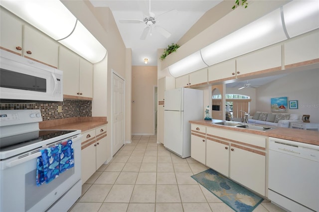 kitchen featuring white cabinetry, lofted ceiling, sink, decorative backsplash, and white appliances