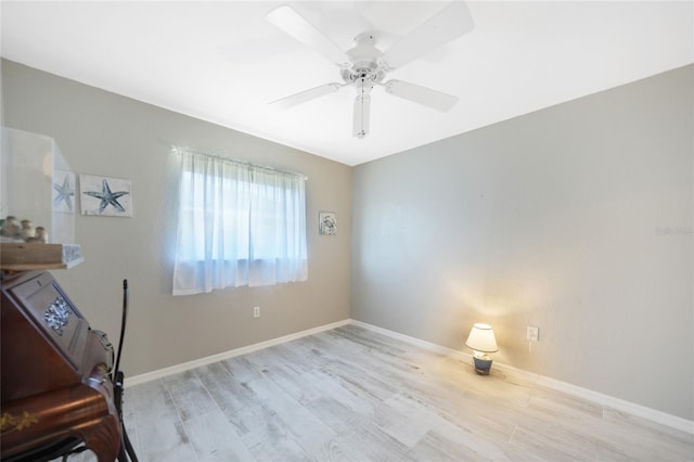 spare room featuring light hardwood / wood-style floors and ceiling fan