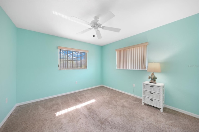 carpeted empty room featuring ceiling fan