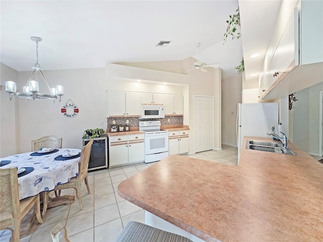 18395 Edgewater Dr, Port Charlotte, FL 33948 - kitchen with white appliances, light tile patterned floors, ceiling fan with notable chandelier, a sink, and visible vents