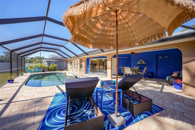 18395 Edgewater Dr, Port Charlotte, FL 33948 - view of swimming pool featuring glass enclosure, a fenced in pool, outdoor dining area, a ceiling fan, and a patio area