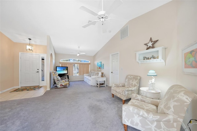 18395 Edgewater Dr, Port Charlotte, FL 33948 - carpeted living area with high vaulted ceiling, visible vents, baseboards, ceiling fan, and tile patterned floors