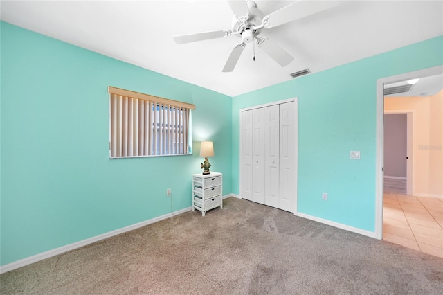 18395 Edgewater Dr, Port Charlotte, FL 33948 - unfurnished bedroom featuring carpet, baseboards, ceiling fan, visible vents, and a closet