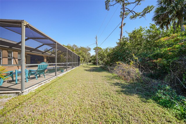 18395 Edgewater Dr, Port Charlotte, FL 33948 - view of yard with glass enclosure, an outdoor pool, and a patio area