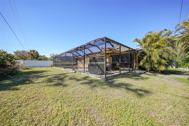 18395 Edgewater Dr, Port Charlotte, FL 33948 - view of yard featuring glass enclosure, fence, and a patio