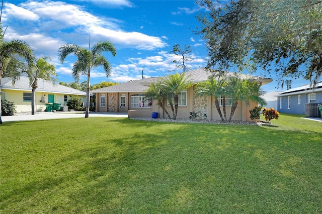 18395 Edgewater Dr, Port Charlotte, FL 33948 - back of property with cooling unit, stucco siding, and a lawn