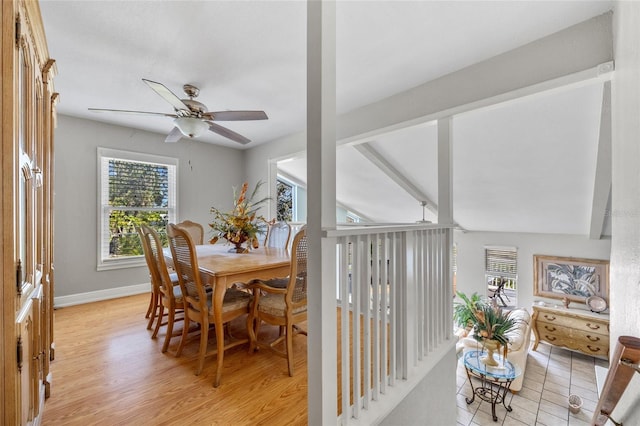 dining room featuring lofted ceiling with beams, ceiling fan, and light wood-type flooring