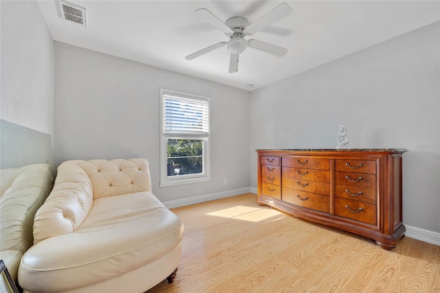 sitting room with ceiling fan and light wood-type flooring