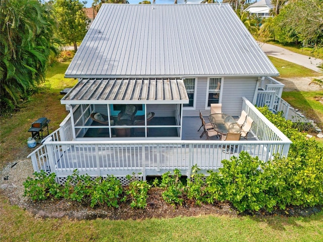 back of house featuring a wooden deck