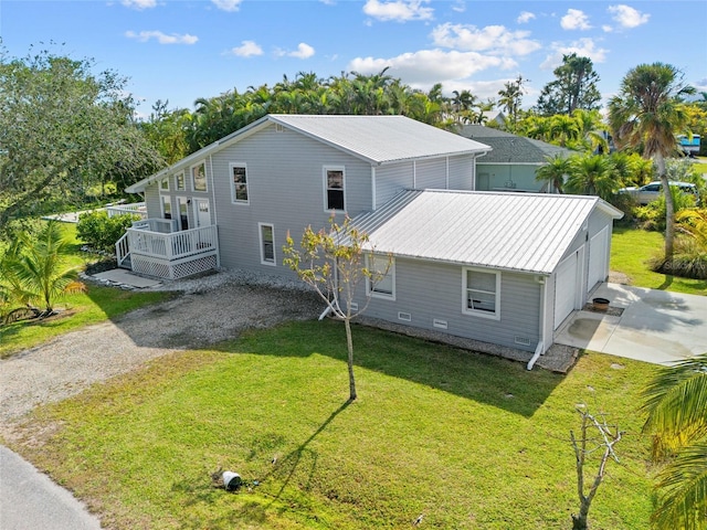 exterior space featuring a garage and a yard