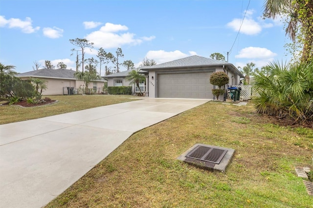 ranch-style house featuring a garage and a front lawn