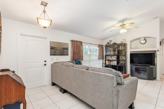 living room with light tile patterned flooring, ceiling fan, and vaulted ceiling