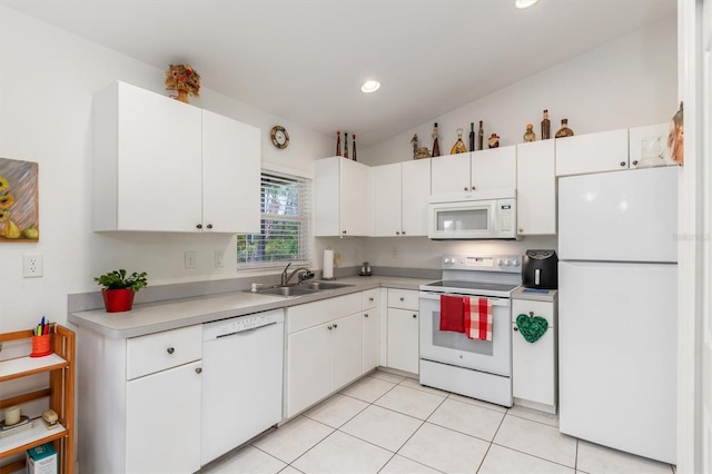 kitchen with light tile patterned flooring, white appliances, sink, and white cabinets