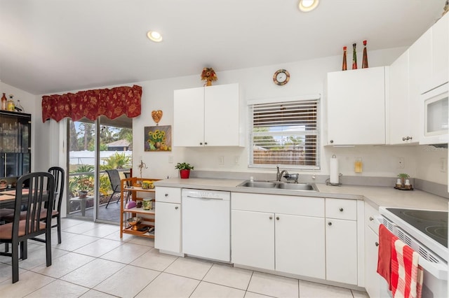 kitchen with sink, a wealth of natural light, white cabinets, and white appliances