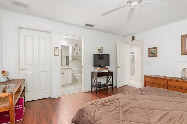 bedroom with ceiling fan, hardwood / wood-style floors, and ensuite bath