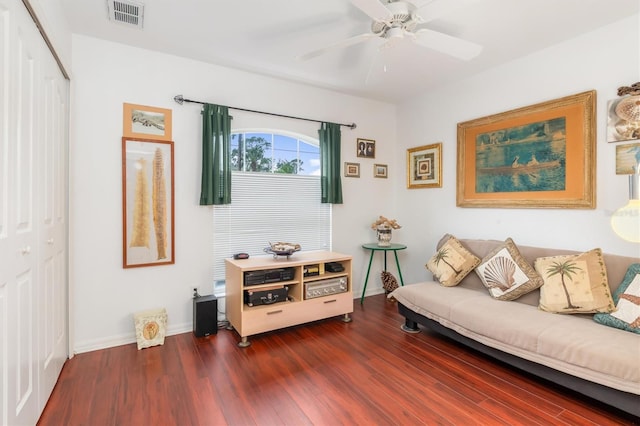 living room with dark hardwood / wood-style flooring and ceiling fan