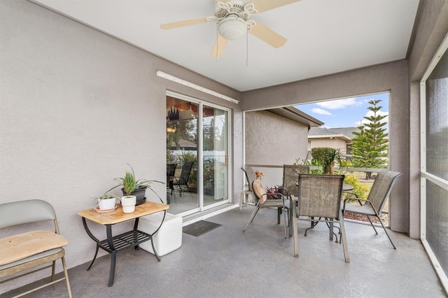 sunroom featuring ceiling fan