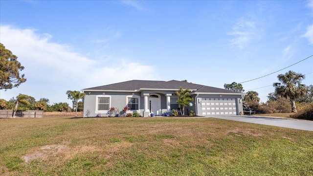 ranch-style house featuring a garage and a front yard