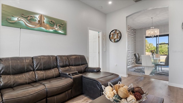 living room featuring hardwood / wood-style flooring and a chandelier