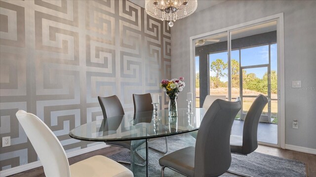 dining room with an inviting chandelier and hardwood / wood-style flooring