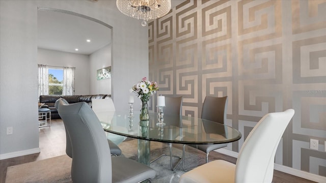 dining area featuring a notable chandelier and wood-type flooring