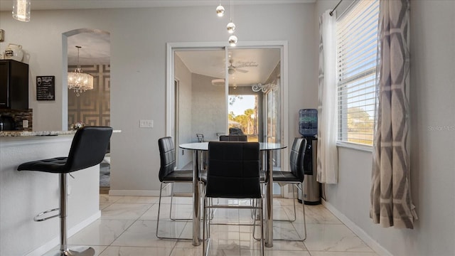 dining space with an inviting chandelier