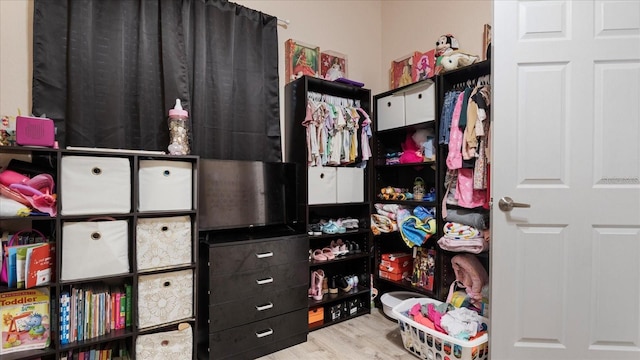 walk in closet with light wood-type flooring