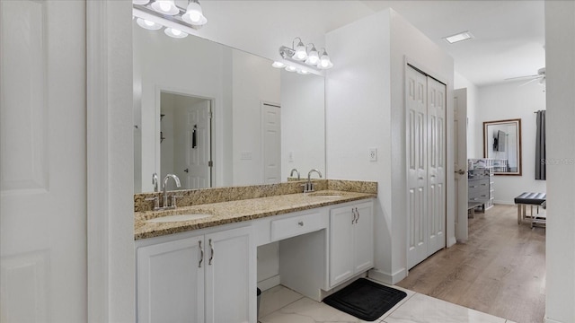 bathroom with ceiling fan, vanity, and wood-type flooring