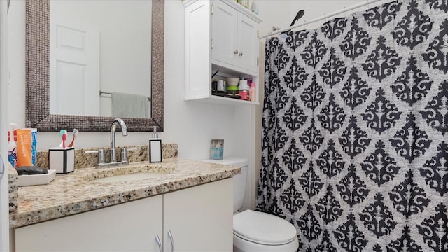 bathroom featuring vanity, a shower with shower curtain, and toilet