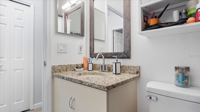 bathroom with toilet and vanity