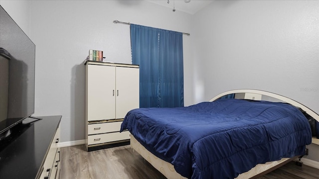 bedroom featuring dark hardwood / wood-style flooring