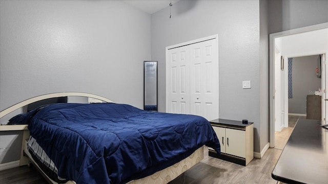 bedroom featuring light hardwood / wood-style floors and a closet