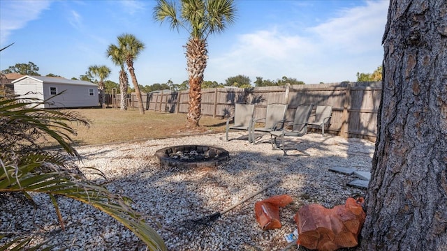 view of yard with a fire pit