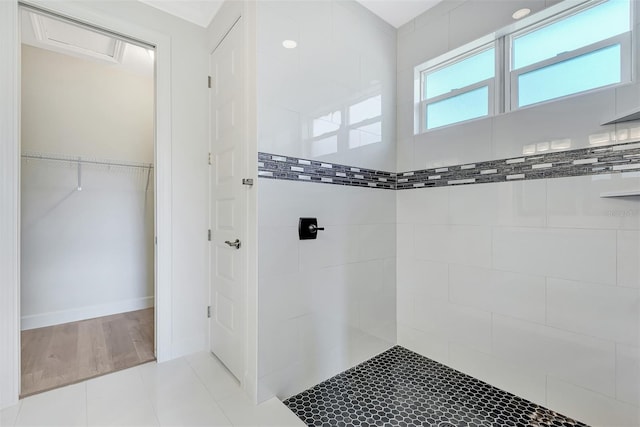 bathroom featuring a tile shower and tile patterned floors