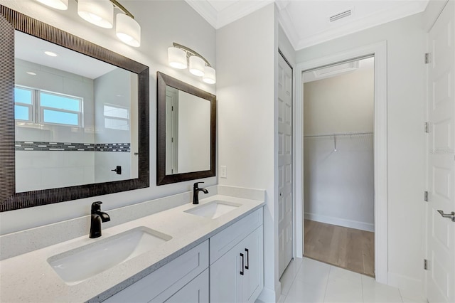 bathroom featuring tile patterned flooring, ornamental molding, vanity, and walk in shower